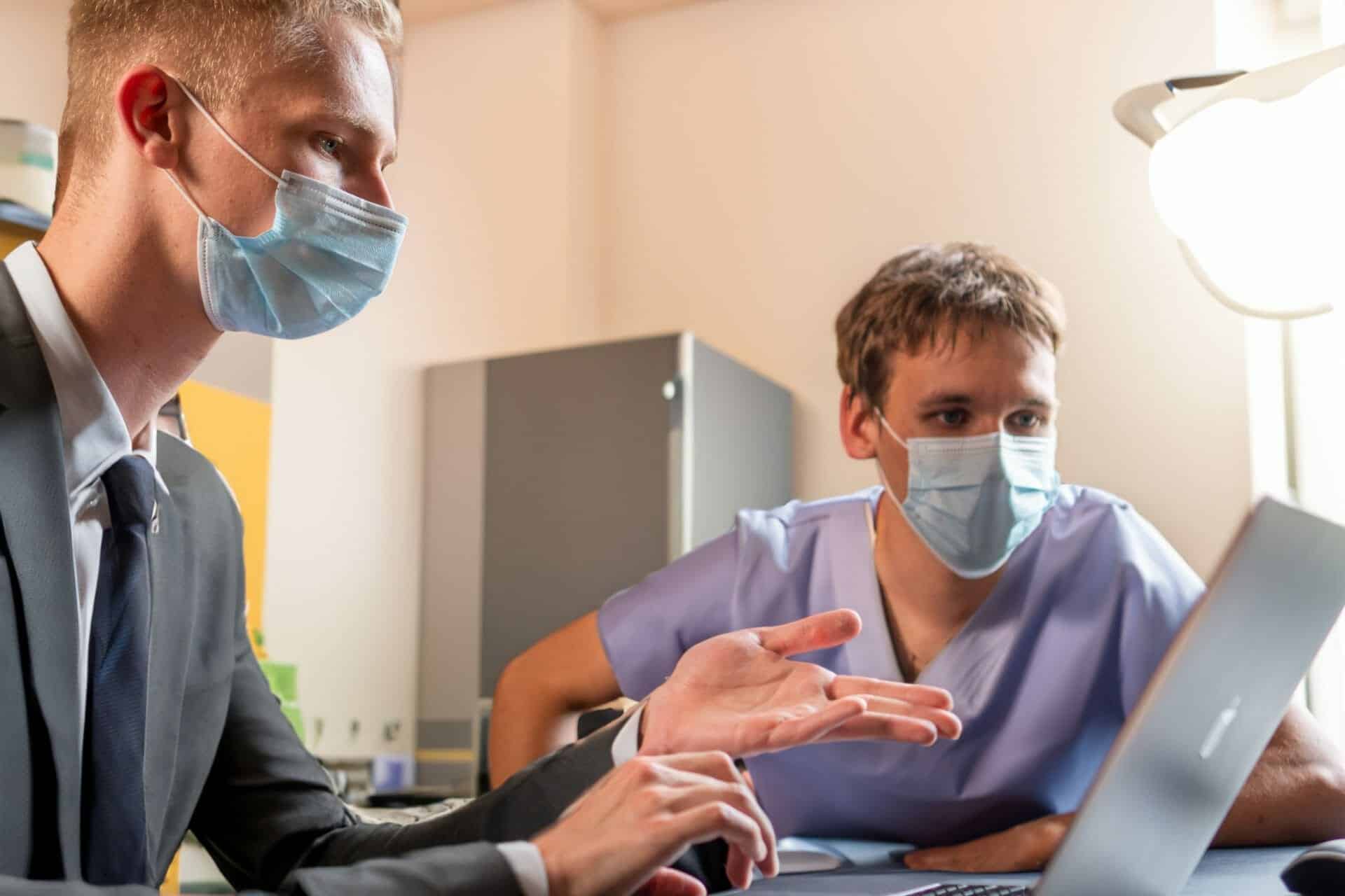 Dental IT support staff discussing service contract at front desk