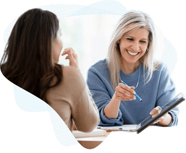 Dental IT consultant reviewing tablet with client during planning session